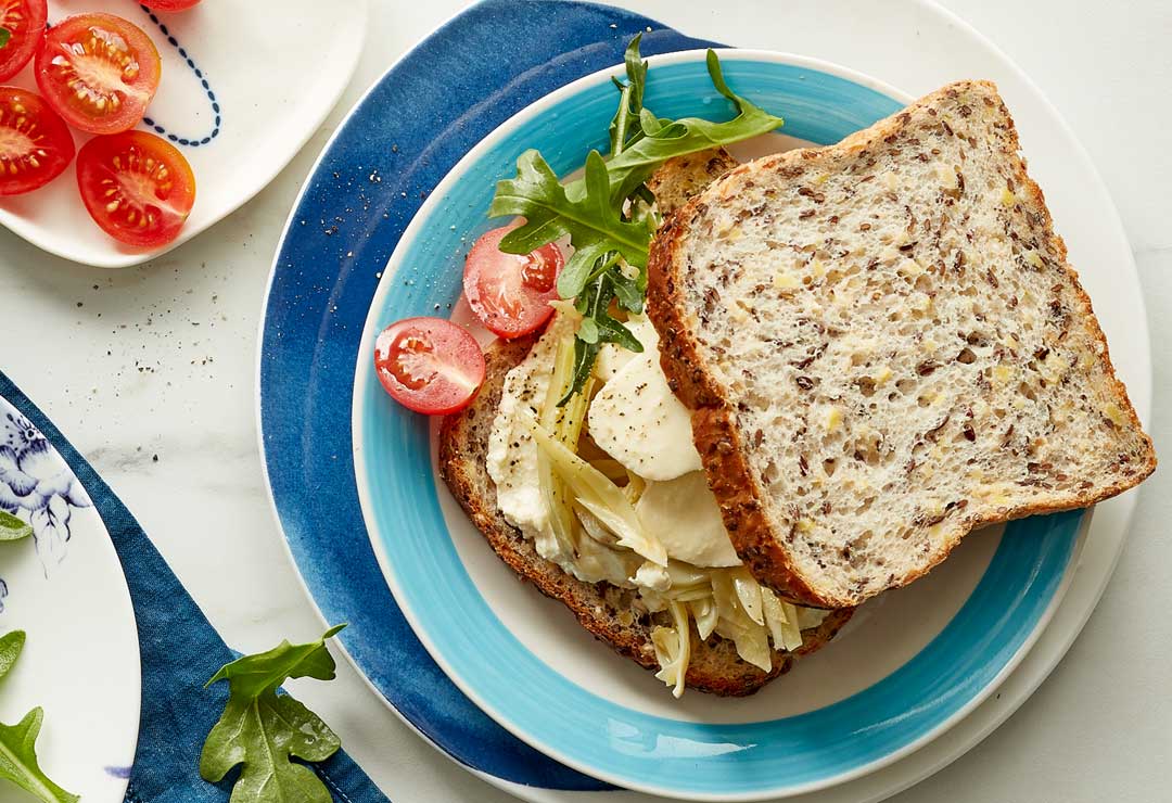 Marinated artichoke sandwich with rocket, bocconcini and baby Roma tomatoes